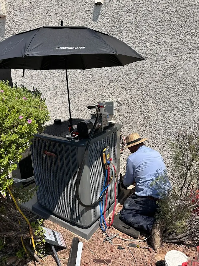 HVAC technician performing outdoor AC maintenance in Calimesa